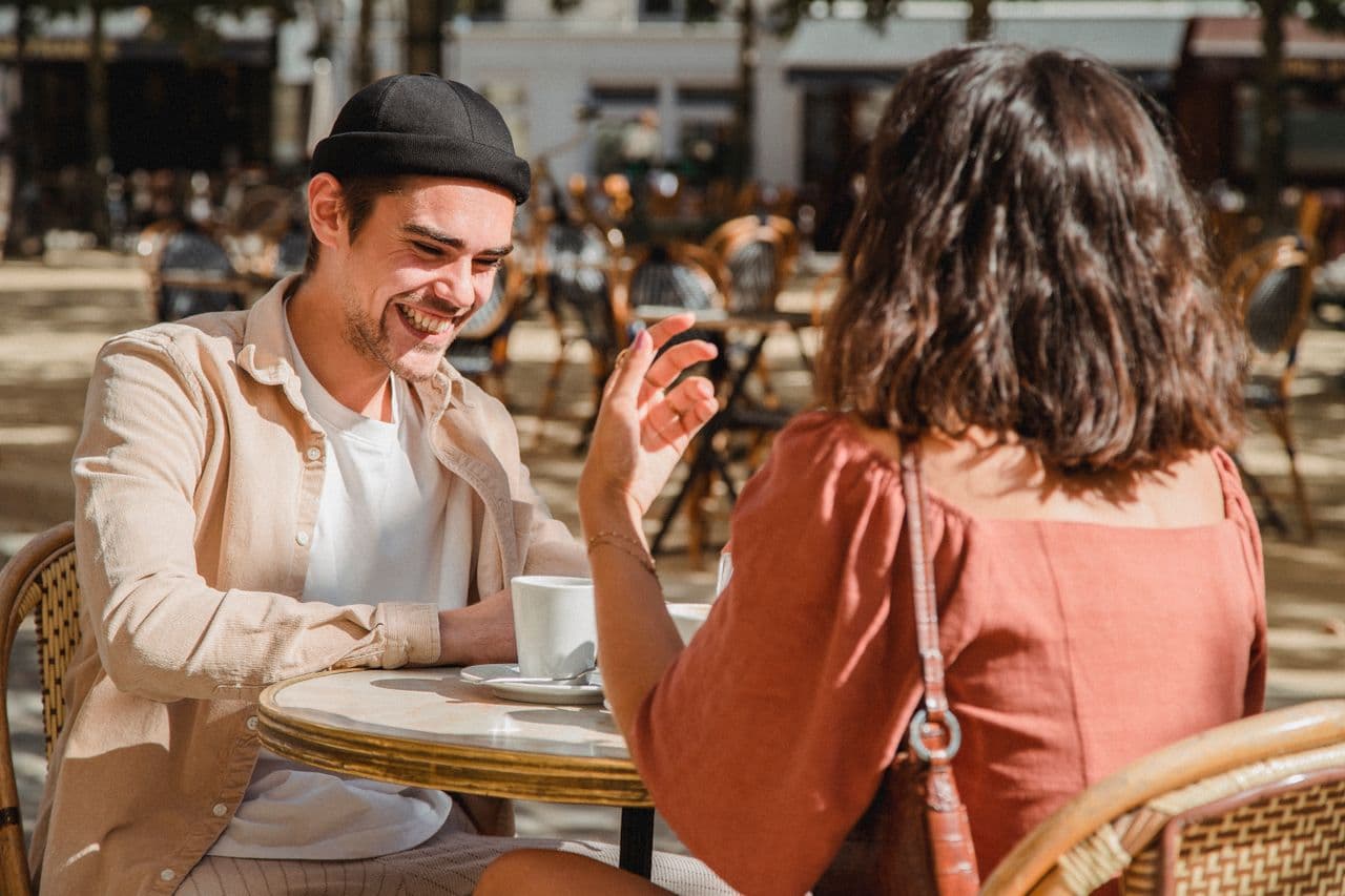 Couple laughing on a cafe date